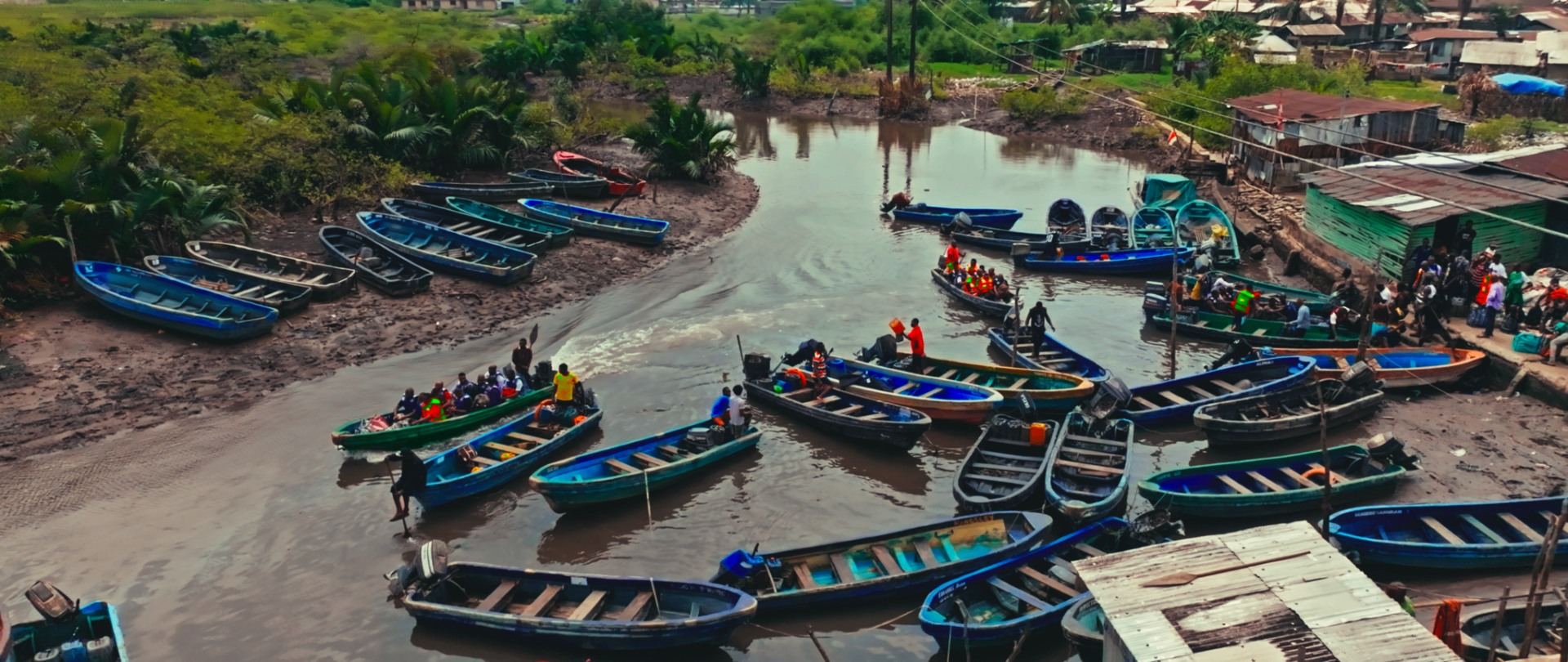 Aerial view of fishing boats along the riverbank village