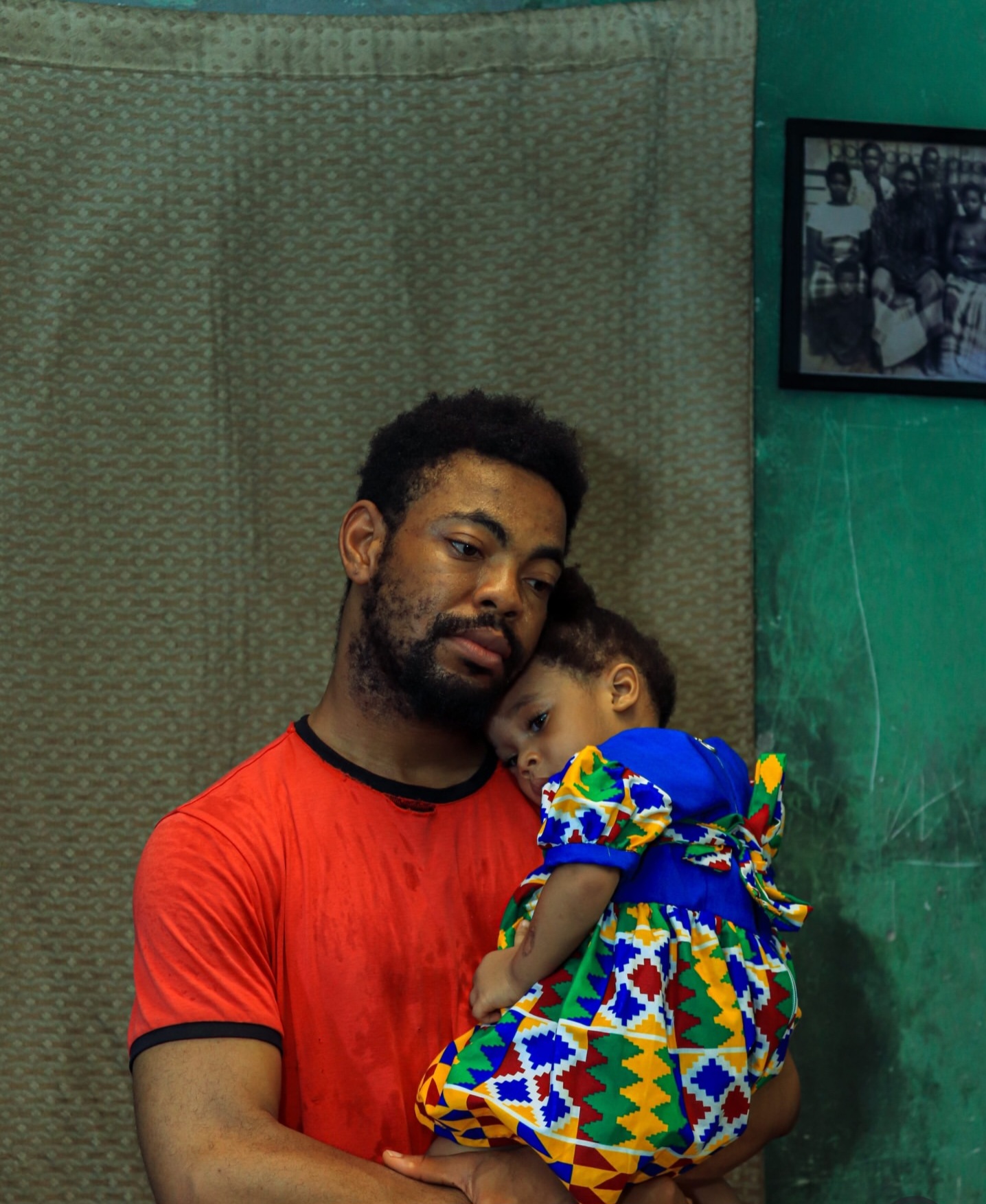 Father cradles his sleeping child