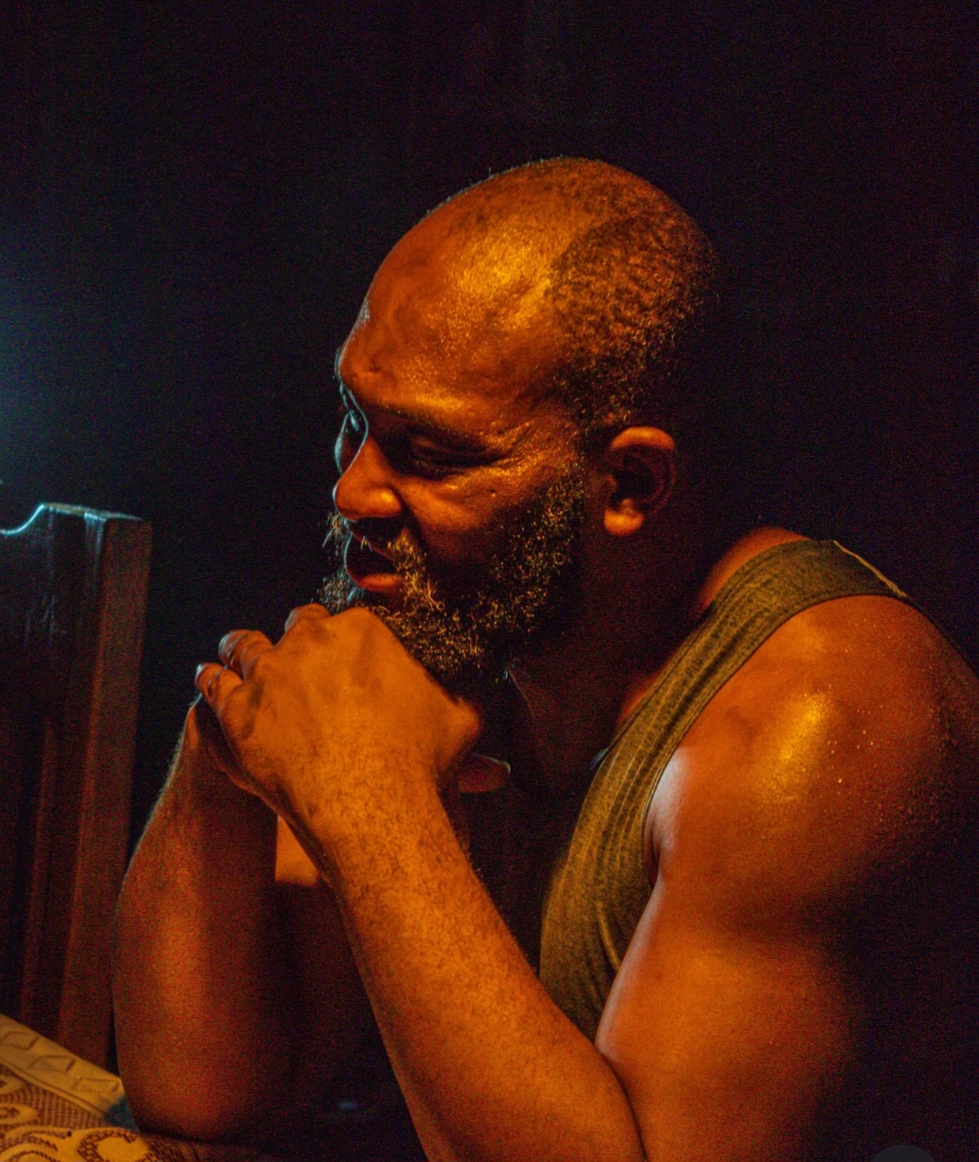 A man in prayer by lamplight